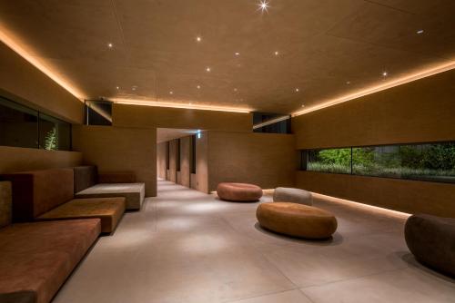 a lobby with couches and stools in a building at Tokyo Bay Shiomi Prince Hotel in Tokyo