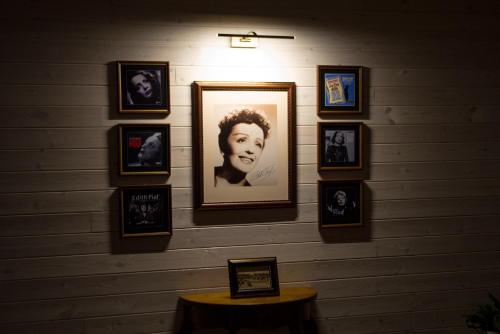 a wall with framed pictures of a woman on it at JURA GLAMP luksusowe całoroczne domki na wyłączność KOPUŁY IGLOO taras ogród in Wola Kalinowska