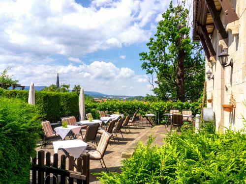 a patio at a winery with tables and chairs at Schlossberg-Hotel Garni in Wernigerode