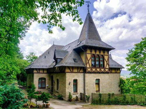 an old house with a tower on top of it at Schlossberg-Hotel Garni in Wernigerode