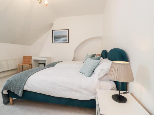 a bedroom with a bed and a table with a lamp at Fairlight View in Folkestone