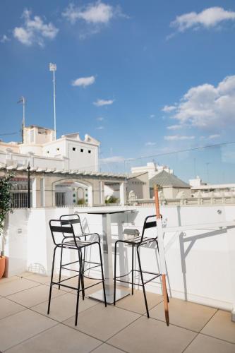 a table and chairs on the roof of a building at MYR Marqués House in Valencia