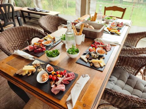 a wooden table with food on top of it at Chambres d'Hotes Le 1900 in Val Couesnon