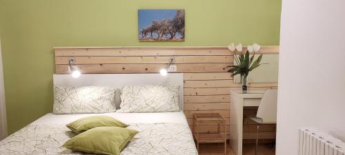 a bedroom with a bed with a wooden headboard and lights at Apulia Bed&Breakfast in Mattinata