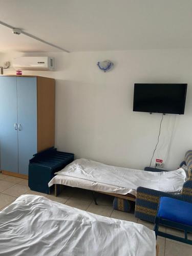 a hospital room with two beds and a flat screen tv at Casa Poseidon in Costinesti