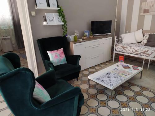 a living room with two chairs and a table at Casa vacanze San Giovanni nei Sassi in Matera