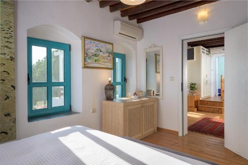 a bedroom with a bed and a bathroom with a sink at Villa Mary's Holiday House in Pefki Rhodes