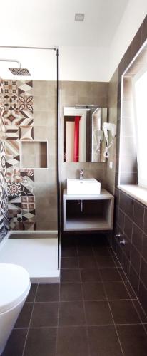 a bathroom with a sink and a shower at Apulia Bed&Breakfast in Mattinata