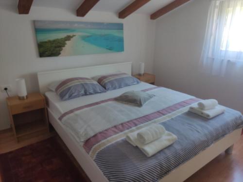 a bedroom with a bed with towels on it at Apartment Ankica in Umag