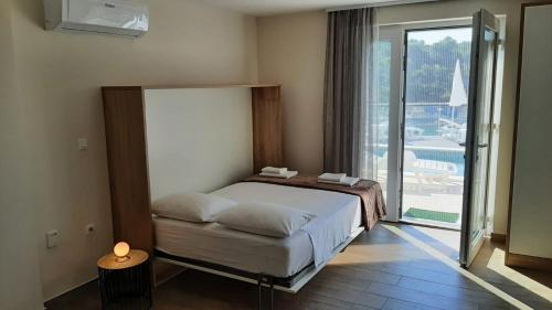 a bedroom with a bed and a large window at Apartment Aurea in Primošten