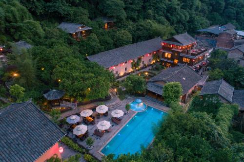 an aerial view of a resort with a swimming pool at Yangshuo Ancient Garden Boutique Hotel in Yangshuo