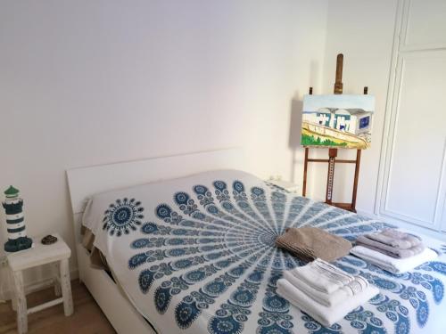 a bedroom with a bed with towels on it at Panoramica Flat in Porto Santo Stefano