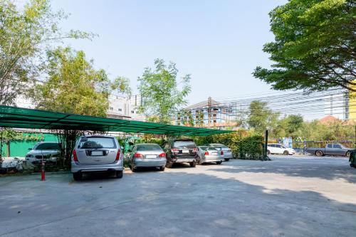 a group of cars parked in a parking lot at The Palm Hotel in Salaya
