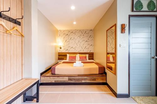 a bedroom with a bed in a room at The Palm Hotel in Salaya