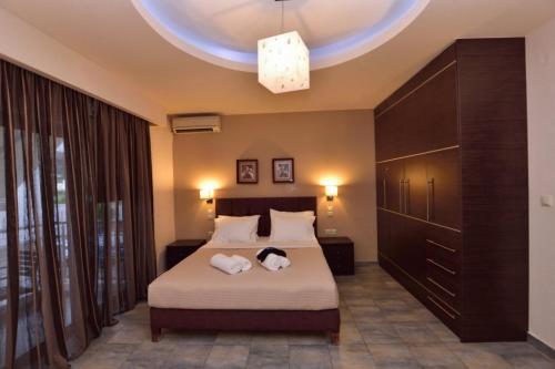a bedroom with a bed with two towels on it at Gonis Suites in Palaiochóra