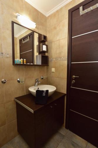 a bathroom with a sink and a mirror at Gonis Suites in Palaiochora