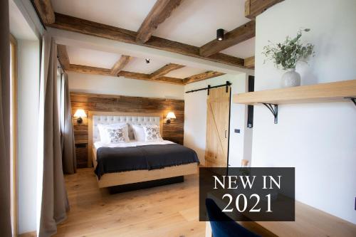 a bedroom with a bed and a sign that says new in at House Troha - Rooms & Apartments in Bled