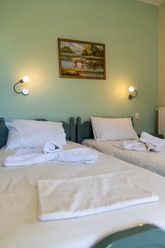 two beds sitting next to each other in a room at Lambrini Studios in Parga