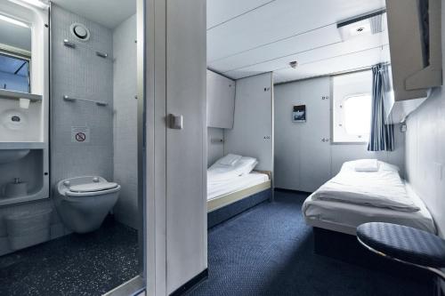 a small room with a bed and a toilet at DFDS Ferry - Amsterdam to Newcastle in IJmuiden