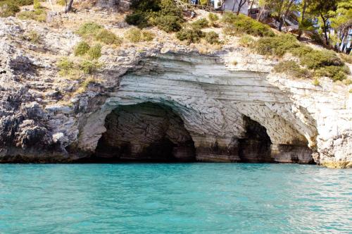 a cave on the side of a rocky cliff at Apulia Bed&Breakfast in Mattinata