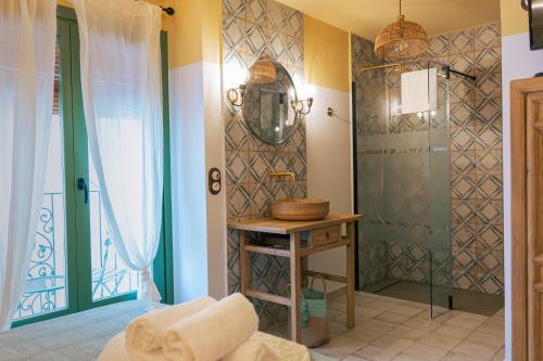 Joanna Hotel في بينييسكولا: حمام مع دش وطاولة في الغرفة