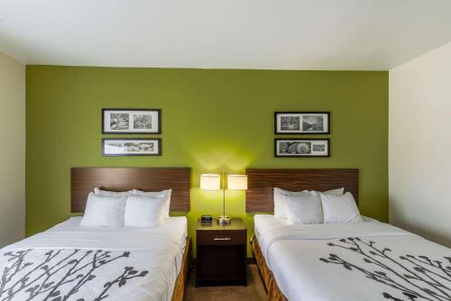 A bed or beds in a room at Sleep Inn & Suites Midland West