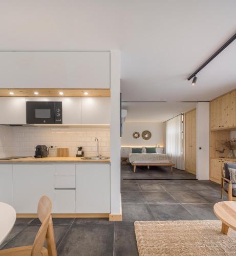 an open kitchen and living room with a couch at Ericeira Prime Villas in Ericeira