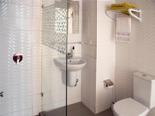 a bathroom with a toilet and a sink at hotel azayla in Asilah