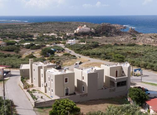 an aerial view of a white building with the ocean in the background at Nireides villas 'TOP DESTINATION' in Elafonisi
