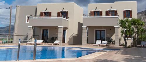 a villa with a swimming pool in front of a house at Nireides villas 'TOP DESTINATION' in Elafonisi