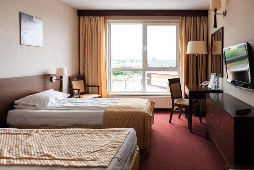 מיטה או מיטות בחדר ב-Hotel Police