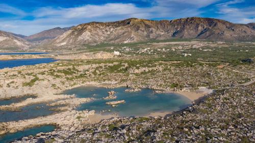 an aerial view of a valley with water and mountains at Nireides villas 'TOP DESTINATION' in Elafonisi