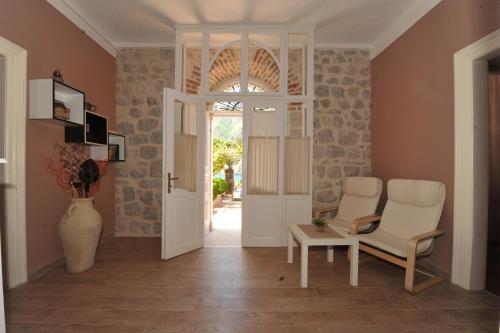 a living room with two chairs and a door at Apartments Marilu in Kotor