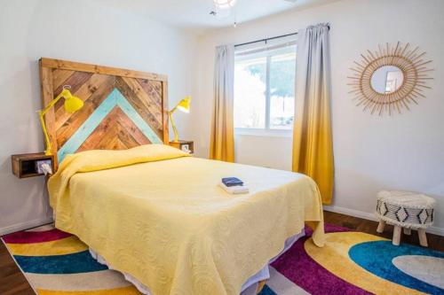 a bedroom with a large bed and a window at New! JT SUNSHINE HOUSE Cozy, Artsy & Comfy, Dog Friendly, 3BD in Joshua Tree
