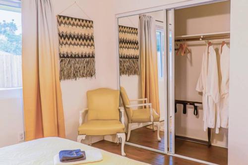 a dressing room with a chair and a mirror at New! JT SUNSHINE HOUSE Cozy, Artsy & Comfy, Dog Friendly, 3BD in Joshua Tree
