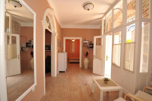 a hallway of a home with a door and windows at Apartments Marilu in Kotor