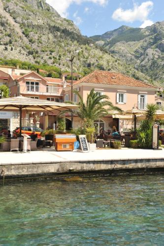 a house next to a body of water at Apartments Marilu in Kotor