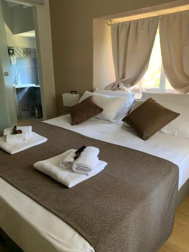 two white towels are sitting on top of a bed at DOMUS FIESCHI Rooms self check in in Genova