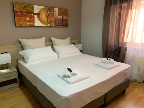 a bedroom with a bed with two towels on it at DOMUS FIESCHI Rooms self check in in Genova