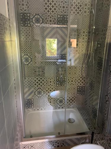 a shower with a glass door in a bathroom at DOMUS FIESCHI Rooms self check in in Genova