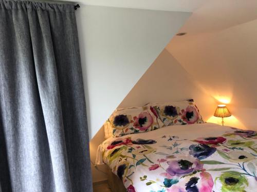 Un pat sau paturi într-o cameră la Plumtree Cottage