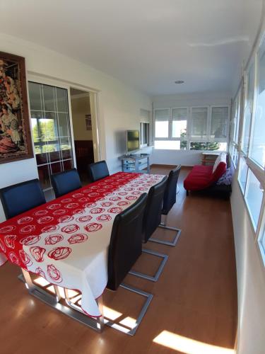 a dining room table with chairs and a red table cloth at Moya, relax en la Calderona in Gilet
