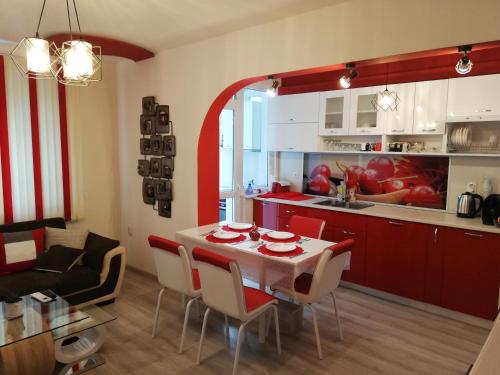a kitchen and dining room with a table and chairs at Apartment Ani in Veliko Tŭrnovo