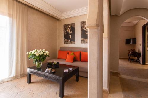 a living room with a couch and a table at Dellarosa Boutique Hotel and Spa in Marrakech