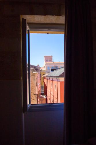 an open window with a view of a city at Locanda Carra Manna in Sassari
