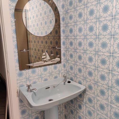 a bathroom with a sink and a mirror at Crow's Nest Glandore - 4 - Self Catering in Glandore
