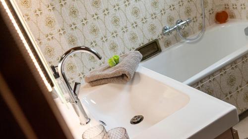 a bathroom sink with a towel and a faucet at Auszeit Aussee in Bad Aussee