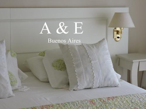een bed met witte kussens en een bordje erop bij A & E Buenos Aires in Buenos Aires