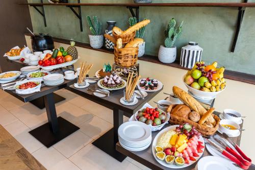 a table filled with lots of food on top at Ulwazi Place Hotel by Trianum in Nairobi