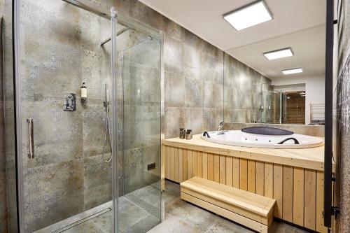 ein Badezimmer mit einer Dusche, einer Badewanne und einem Waschbecken in der Unterkunft NOOK NOOK Apartments Katarzyny 2 in Krakau